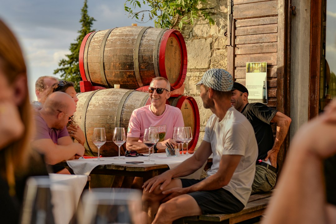 global culinary tourism new — group of travelers tasting wine at a vineyard