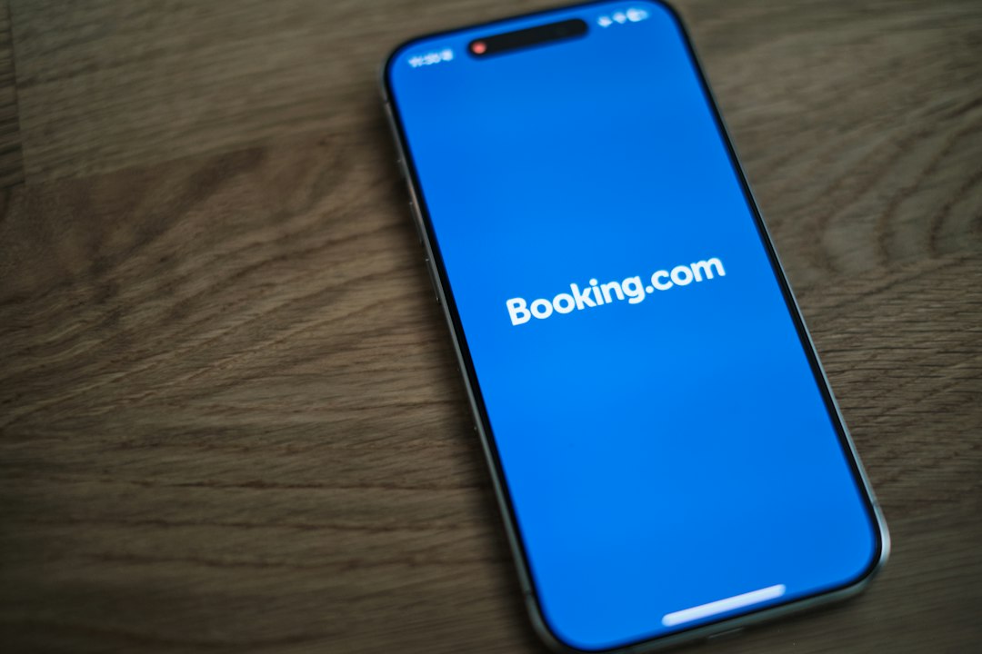 tourism investment emerging destinations — mobile phone showing travel booking app with destination photos